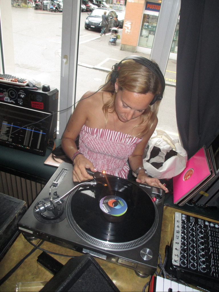 Mina DJing on a vinyl turntable by a window